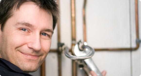 plumber repairing pipes with spanner